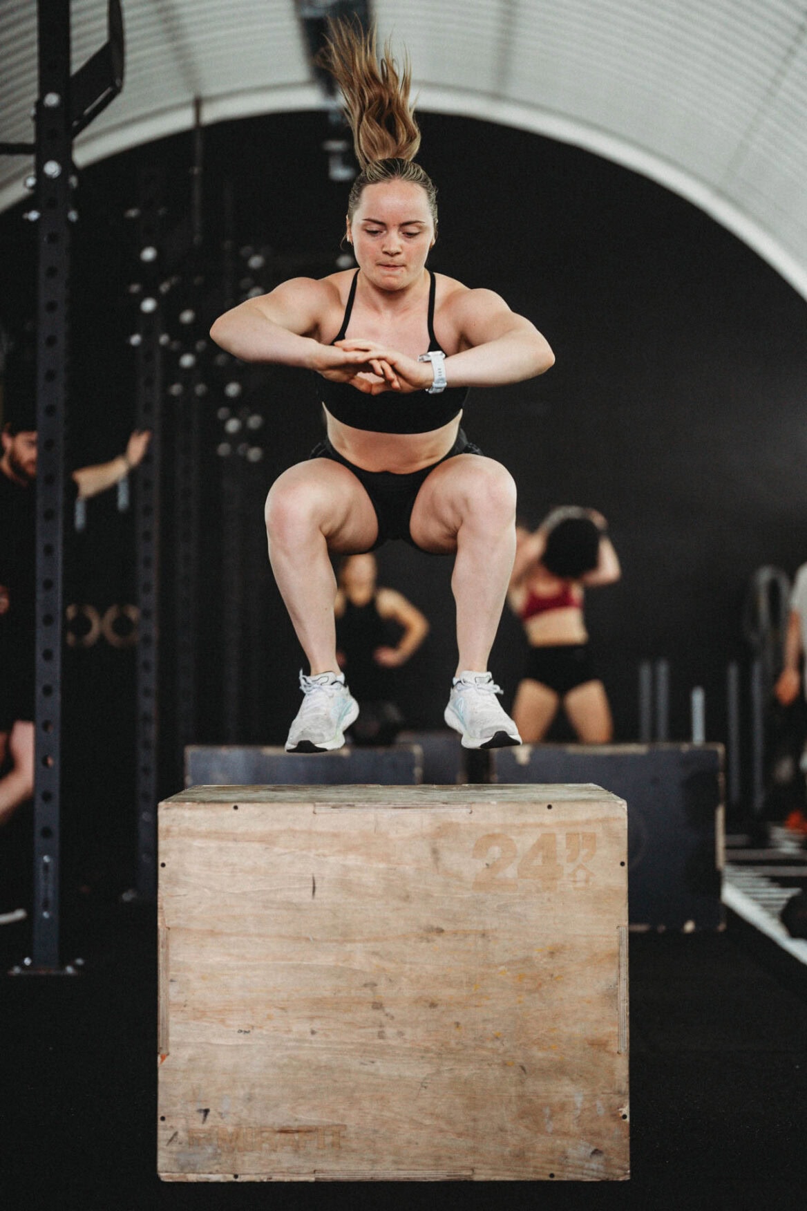 Erin Dodds performing a box jump in a fitness class